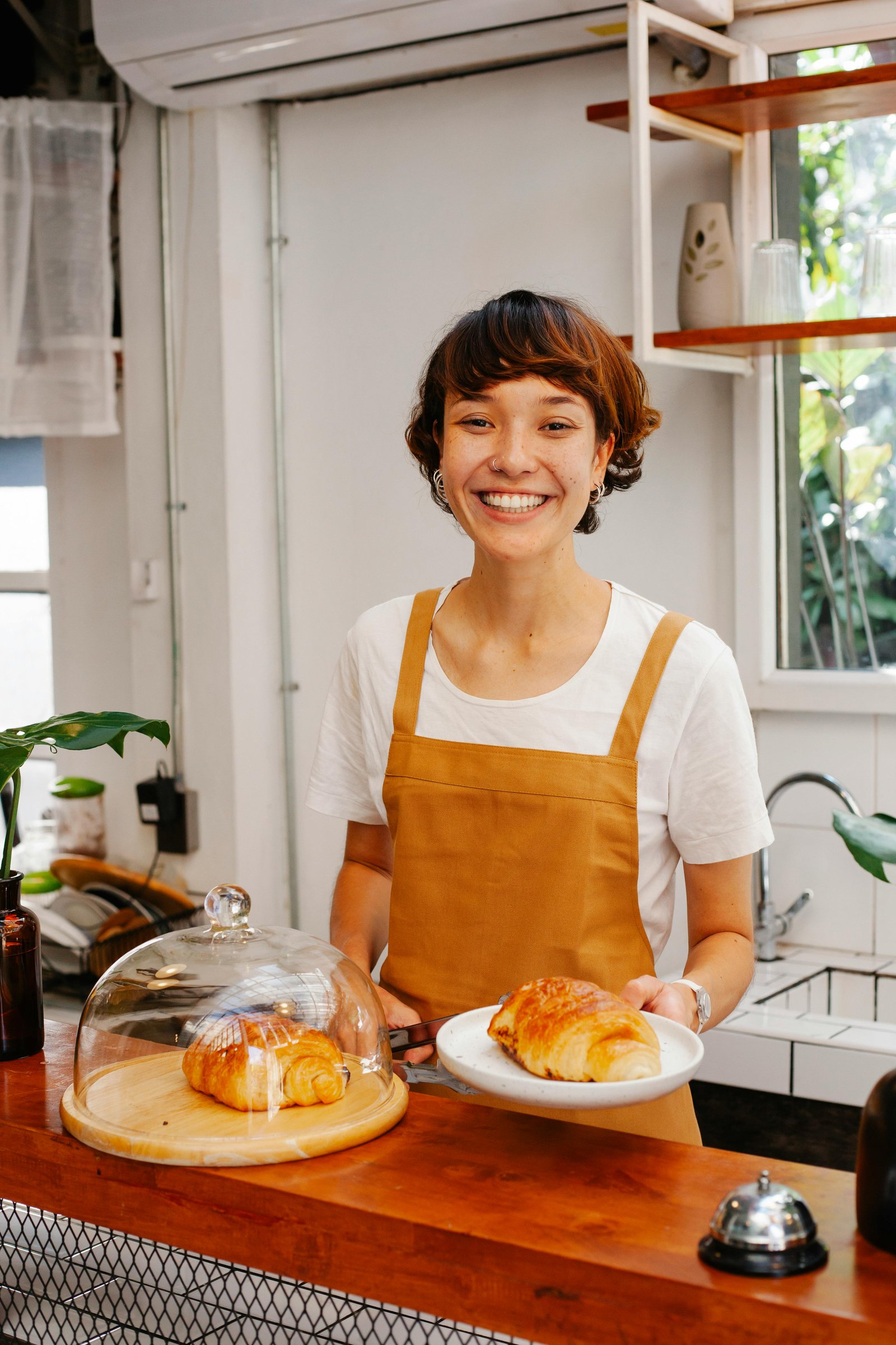 Portrait of a female chef in a busy kitchen
